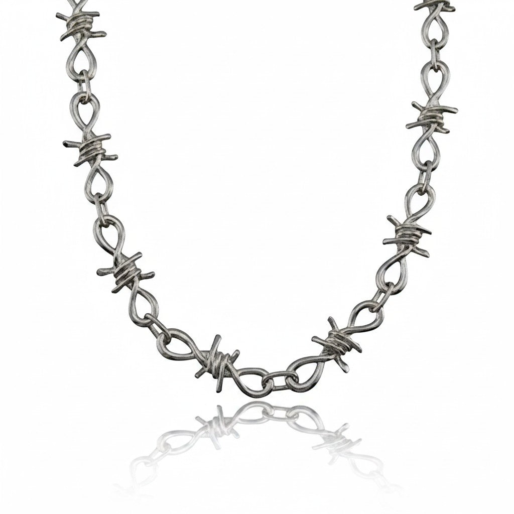 Maniac silver stainless steel barbed wire chain bracelet with intricate links and a punk aesthetic.
