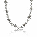 Maniac silver stainless steel barbed wire chain bracelet with intricate links and a punk aesthetic.