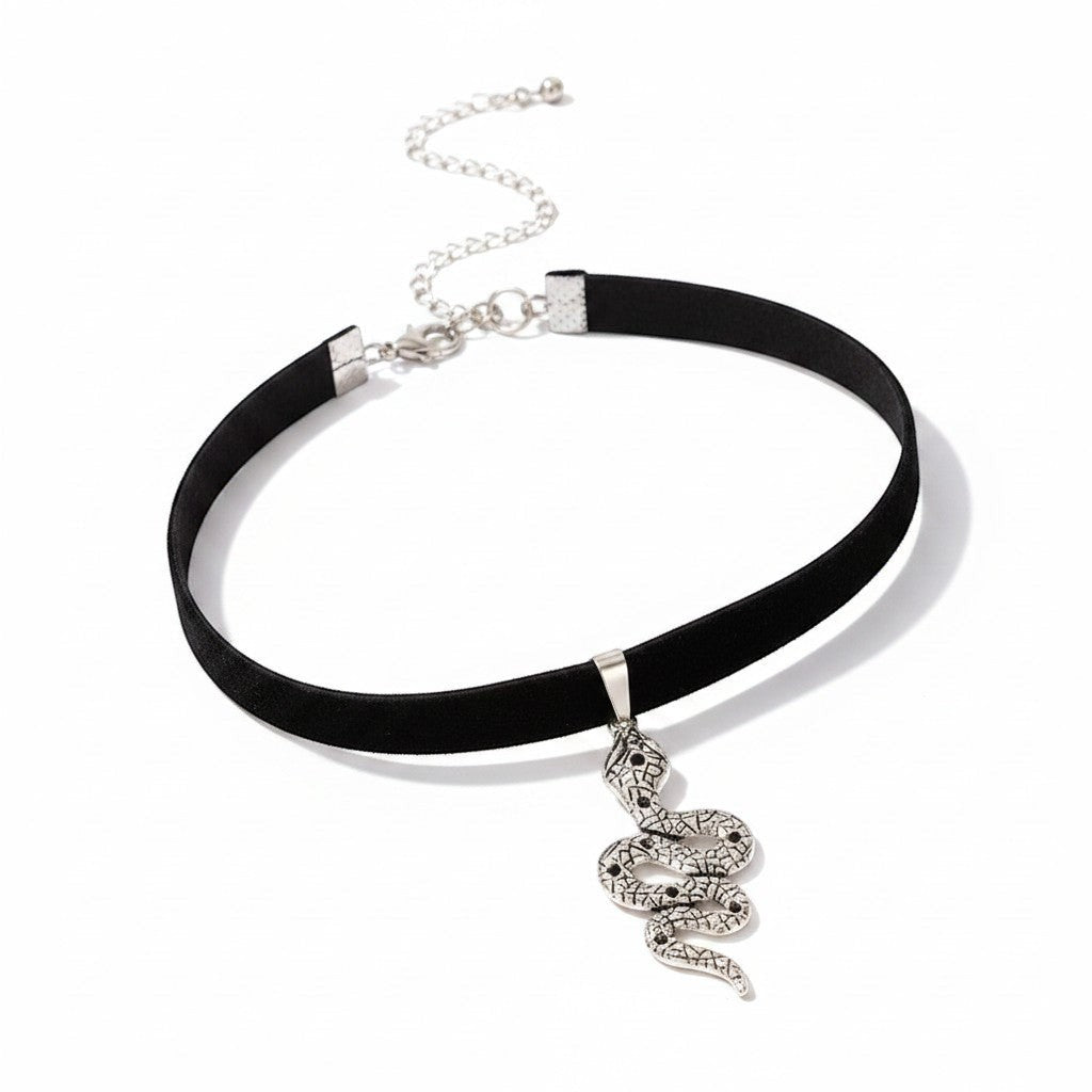Maniac black velvet choker necklace with a silver snake pendant adorned with black stones.