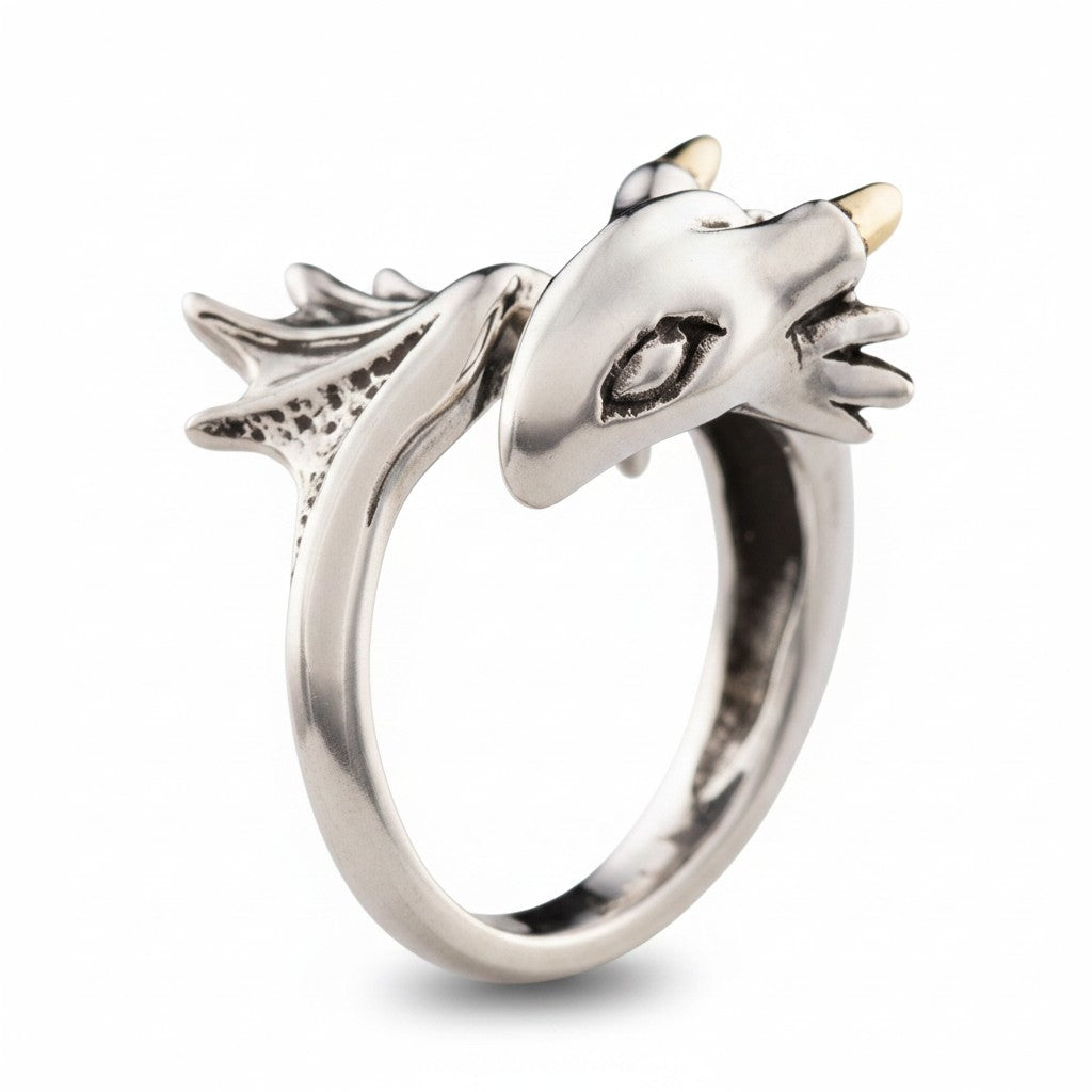 Maniac silver stainless steel ring designed as a small flying dragon with textured wings and gold accents.
