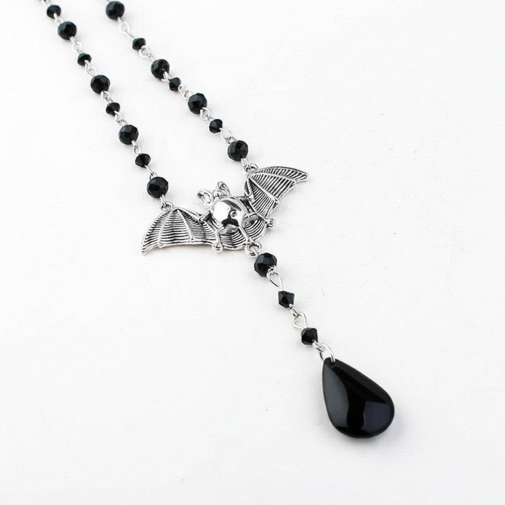 Maniac gothic bat necklace with black beads and a teardrop pendant, made of stainless steel.