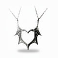 Maniac silver and black stainless steel gothic devil wing couple necklaces forming a heart.