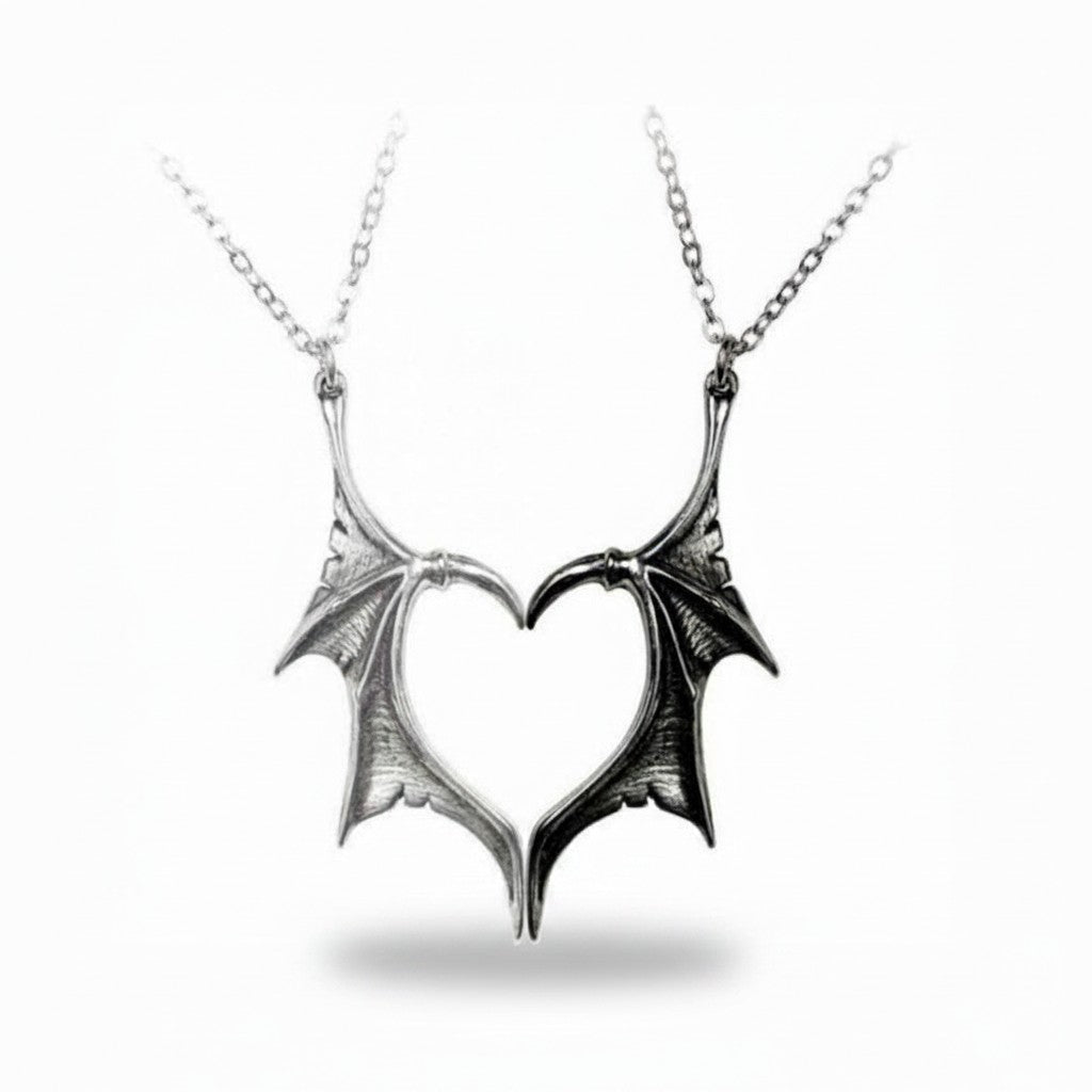 Maniac silver and black stainless steel gothic devil wing couple necklaces forming a heart.