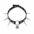 Maniac black faux leather choker necklace with silver spider and spike charms. Adjustable punk style.