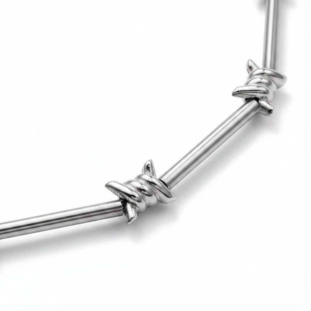 Maniac silver stainless steel barbed wire choker necklace with lobster clasp closure.