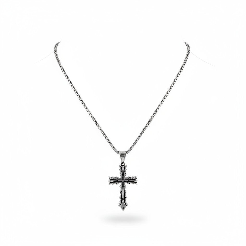 Maniac silver stainless steel cross pendant necklace with intricate detailing, worn by a person.