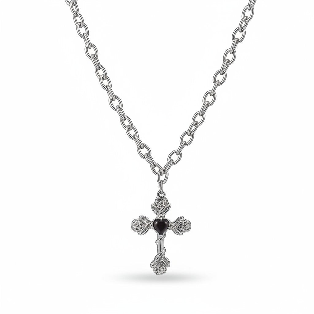 Maniac silver stainless steel cross necklace with rose details and black heart center. Adjustable chain.