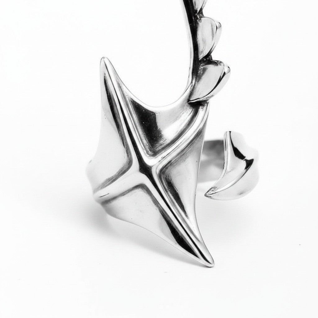 Maniac silver stainless steel irregular ring with a unique star-like design and pointed accents.