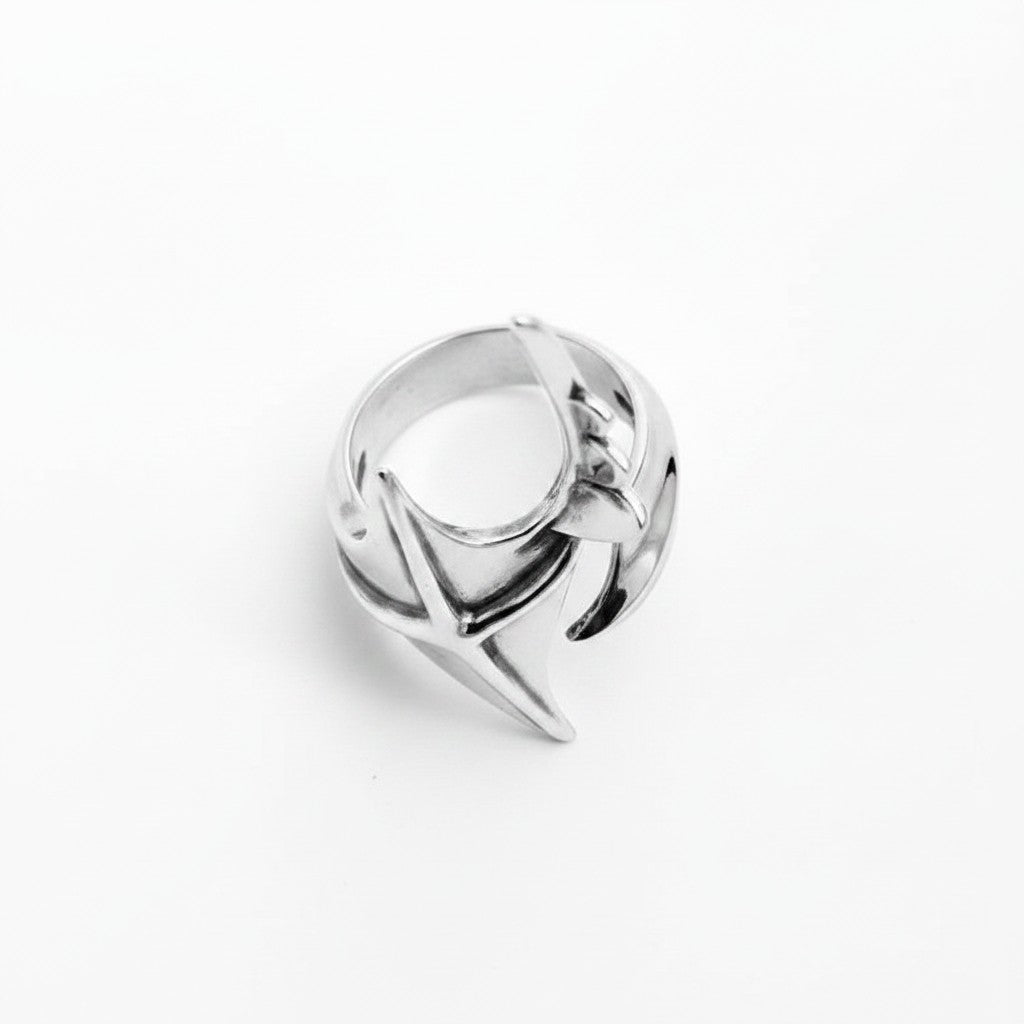 Maniac silver stainless steel irregular ring with a unique star-like design and a pointed, elongated top.