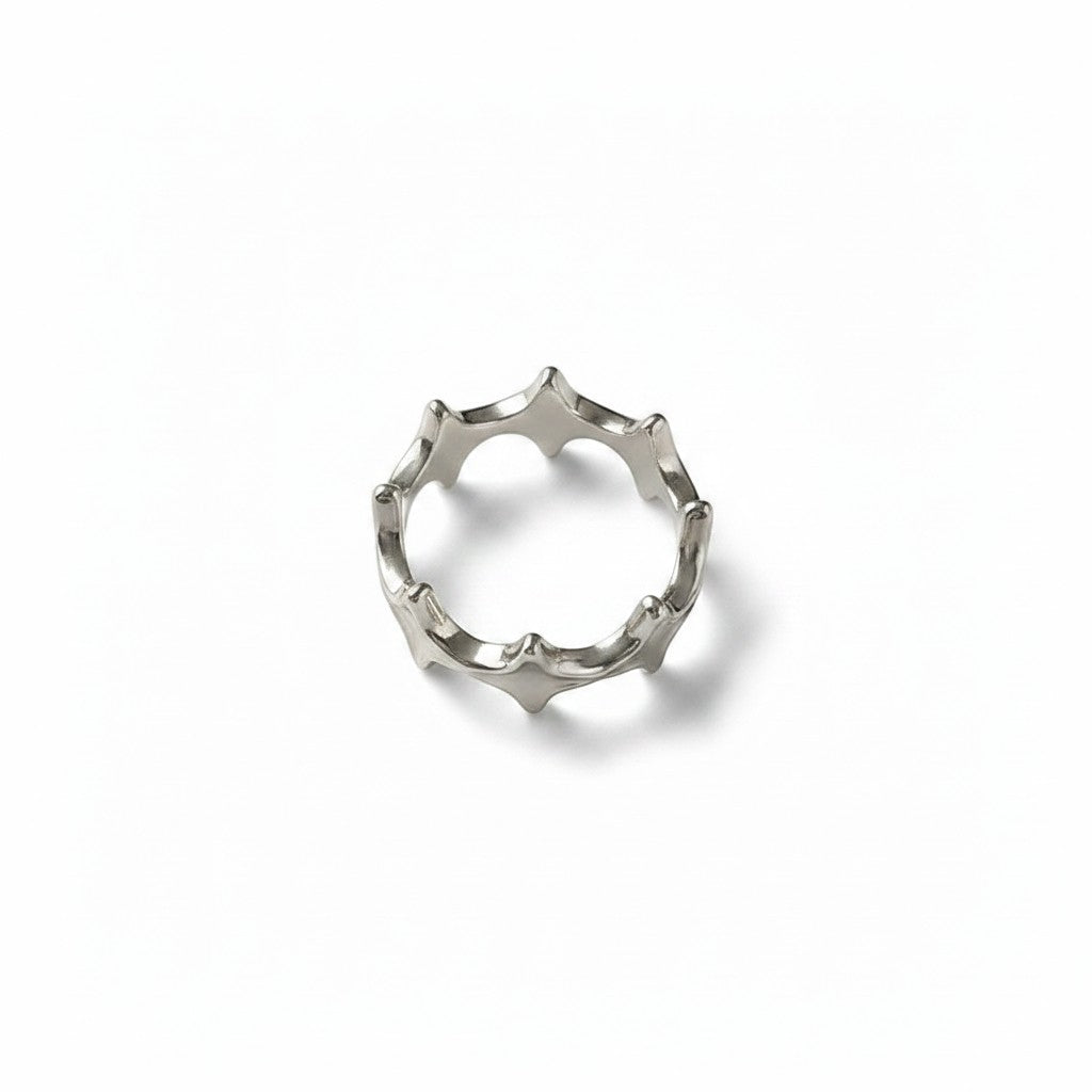 Maniac silver stainless steel open-end ring with irregular four eight-pointed stars design.