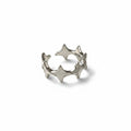 Maniac silver stainless steel open-end ring with irregular four and eight-pointed stars.