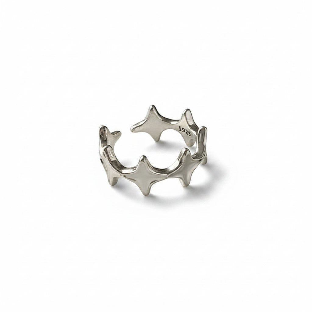 Maniac silver stainless steel open-end ring with irregular four and eight-pointed stars.